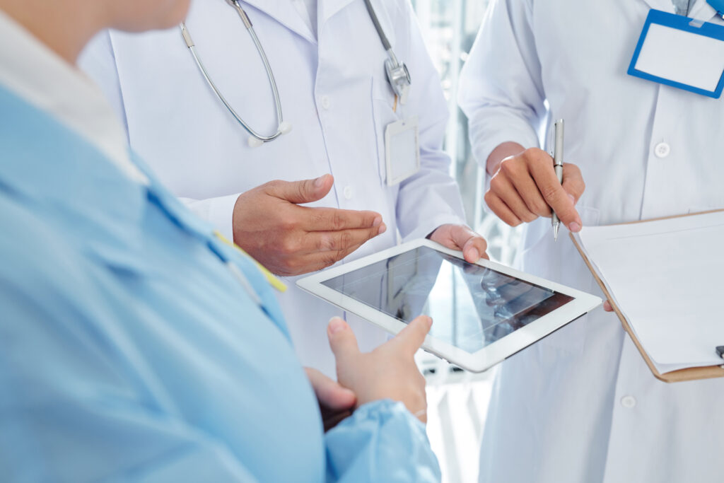 Hospital and healthcare workers using table to access the cloud-based platform Creative Health Care Insight